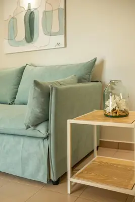 a living room with a couch and a table at Koutris Apartment 1 in Falasarna