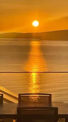 a sunset over the water on a boat at Seascape Kalyves in Kalyves