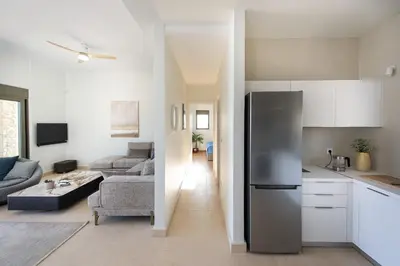 a kitchen and a living room with a refrigerator at Seascape Kalyves in Kalyves