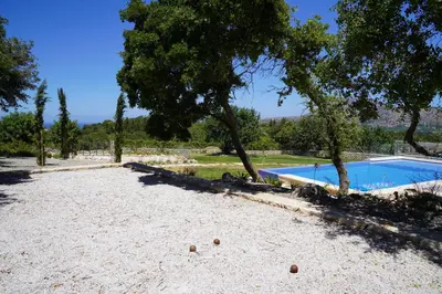 a yard with a swimming pool and some trees at Villa Annie Crete - Private Luxury Villa with Sea and Mountain Views in Tsivarás