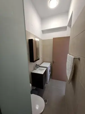a small bathroom with a toilet and a sink at Olea Homes in Plátanos