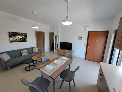a living room with a couch and a table and chairs at Olea Homes in Plátanos