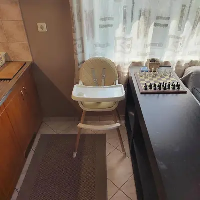 a high chair with a chess board on a counter at Rododafni Apartments in Kolymvari