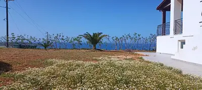 a white building with a view of the ocean at Casa Lazareta in Chania Town