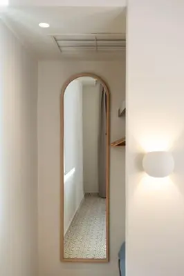 a hallway with a mirror in a bathroom at Once Upon a Home in Chania Town