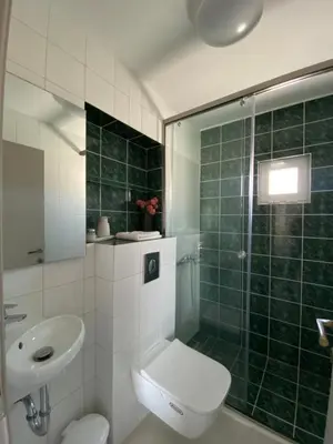 a bathroom with a shower and a toilet and a sink at Άγιος Ιωάννης in Chania Town