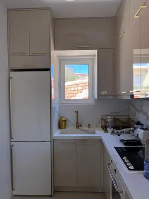 a kitchen with a white refrigerator and a window at Άγιος Ιωάννης in Chania Town