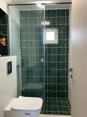 a bathroom with a toilet and a glass shower at Άγιος Ιωάννης in Chania Town