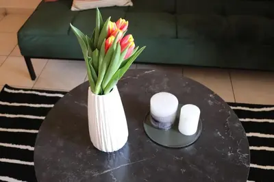 a vase with flowers on a table in a living room at Down Town apartment 27a in Chania Town