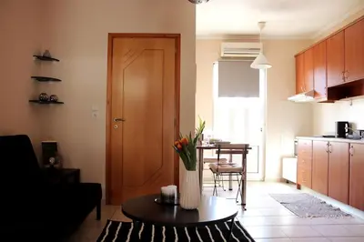 a living room with a vase of flowers on a table at Down Town apartment 27a in Chania Town