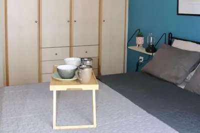 a bed with a table with bowls and plates on it at Down Town apartment 27a in Chania Town