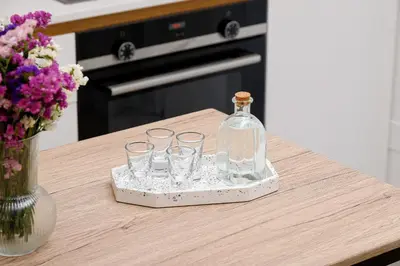 a bottle on a tray with glasses on a table at Penny's Apartment in Chania Town