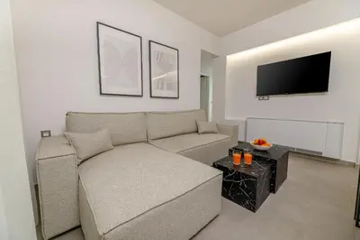 a living room with a couch and a flat screen tv at Penny's Apartment in Chania Town