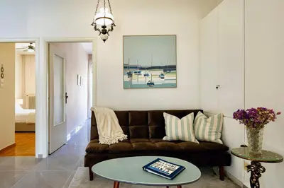a living room with a couch and a table at Modern & Spacious Flat - Chania Center - Walk To Sea in Chania Town
