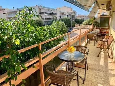 a patio with a table and chairs on a balcony at Modern & Spacious Flat - Chania Center - Walk To Sea in Chania Town