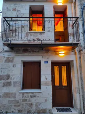 a building with a balcony and two doors at Ploumi in Chania Town