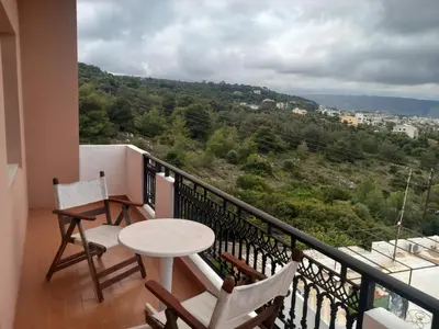 a balcony with a table and chairs and a view at Villa Nancy in Chania Town