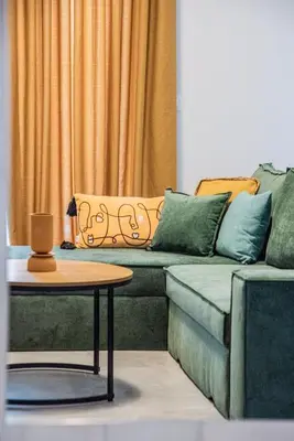 a living room with a couch and a table at Luxury Chic Retreat Suites in Chania Town