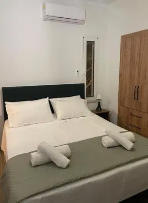 a bedroom with a large bed with towels on it at Moments in Áptera