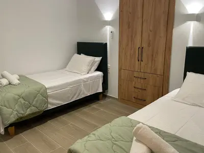 a bedroom with two beds and a wooden cabinet at Moments in Áptera
