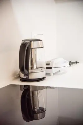 a coffee maker sitting on a table with a phone at Boho Chic Retreat Suite in Chania Town