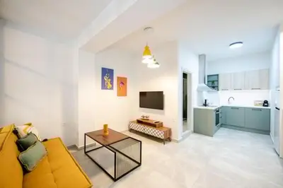 a living room with a couch and a table at Boho Chic Retreat Suite in Chania Town
