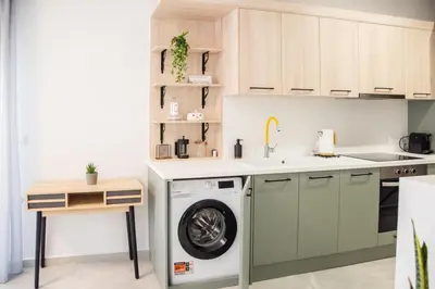 a kitchen with a washing machine and a sink at Minimal Chic Retreat Suite in Chania Town