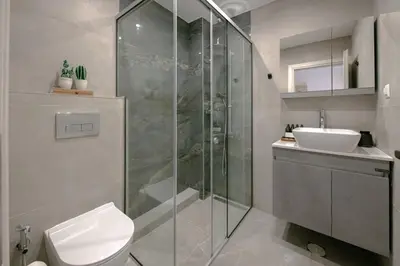 a bathroom with a shower and a toilet and a sink at Minimal Chic Retreat Suite in Chania Town