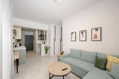 a living room with a couch and a table at Minimal Chic Retreat Suite in Chania Town