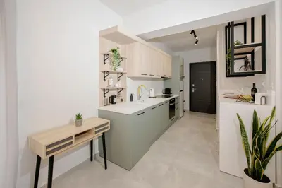 a kitchen with a sink and a table in it at Minimal Chic Retreat Suite in Chania Town
