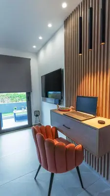 a office with a desk with a laptop and a chair at Seascape Luxury Apartment in Kounoupidhianá