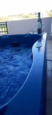 a blue swimming pool with a blue at Emmanuel apartment in Agia Marina Nea Kydonias