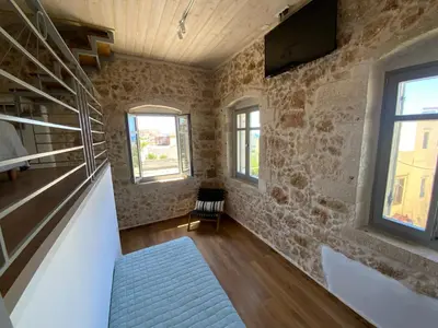 a room with a staircase and two windows at Kazalakis Chania Harbor Roof top retreat in Chania Town