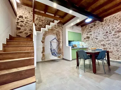 a kitchen and a dining room with a table and chairs at Kazalakis Chania Harbor Roof top retreat in Chania Town