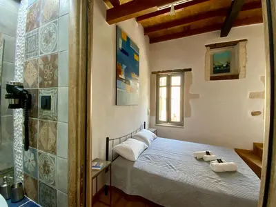 a bedroom with a bed with two towels on it at Kazalakis Chania Harbor Roof top retreat in Chania Town