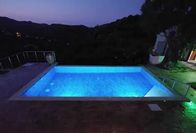 a swimming pool at night with blue lights at Impressive Platanias Villa Villa Bulma 2 Bedrooms Private Pool in Plataniás
