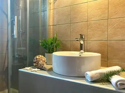 a bathroom with a sink and a shower at Impressive Platanias Villa Villa Bulma 2 Bedrooms Private Pool in Plataniás