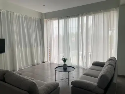 a living room with a couch and a table at Karamela Apartment in Kambánion