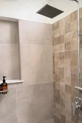 a bathroom with a shower with a shower head at Karamela Apartment in Kambánion