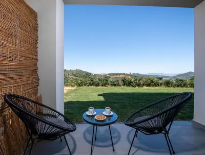 a patio with two chairs and a table with food on it at Arithea Villa in Chania Town
