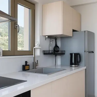 a kitchen with a sink and a refrigerator at Paliochora Beachfront Escape, Milolithos Pool Retreats in Palaiochóra