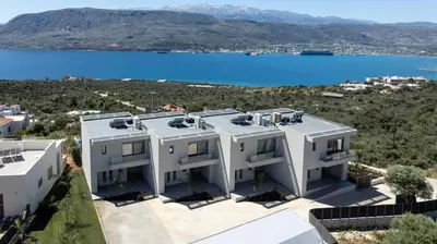 an image of a house with a view of the water at Punto De Vista Luxury Villas in Korakiaí