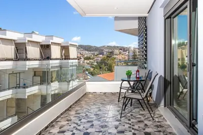 a balcony with a table and chairs on a building at Mariam Luxury Apartments in Chania Town