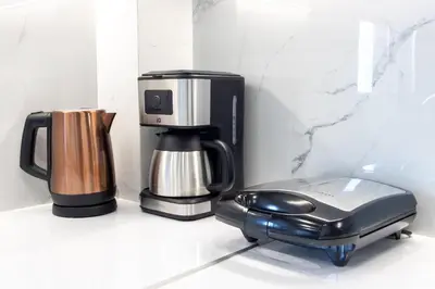 a coffeemaker and a coffee maker on a counter at Mariam Luxury Apartments in Chania Town