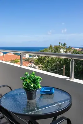 a blue table on a balcony with a plant on it at Mariam Luxury Apartments in Chania Town