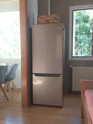 a white refrigerator in a room with a window at Banana Leaves Flat in Chania Town