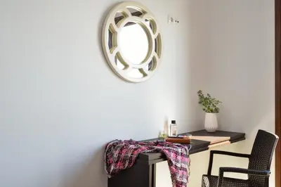 a room with a table and a mirror on the wall at Livaniana Panoramic View House 1 in Livanianá