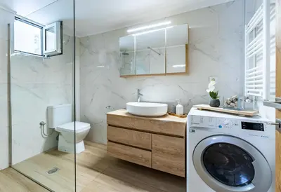 a bathroom with a washing machine and a sink at Corso Venezia Luxury Apartment 3BR in Chania Town