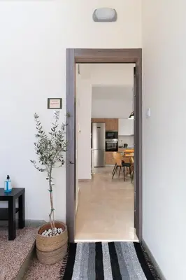 a hallway leading into a living room with a plant at Corso Venezia Luxury Apartment 3BR in Chania Town