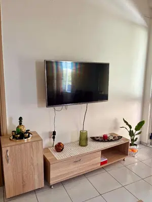 a living room with a flat screen tv on the wall at Yasemi Chania Residences in Chania Town